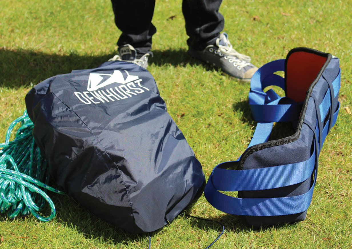 Harness packed into Dewhurst-branded carry bag on grass